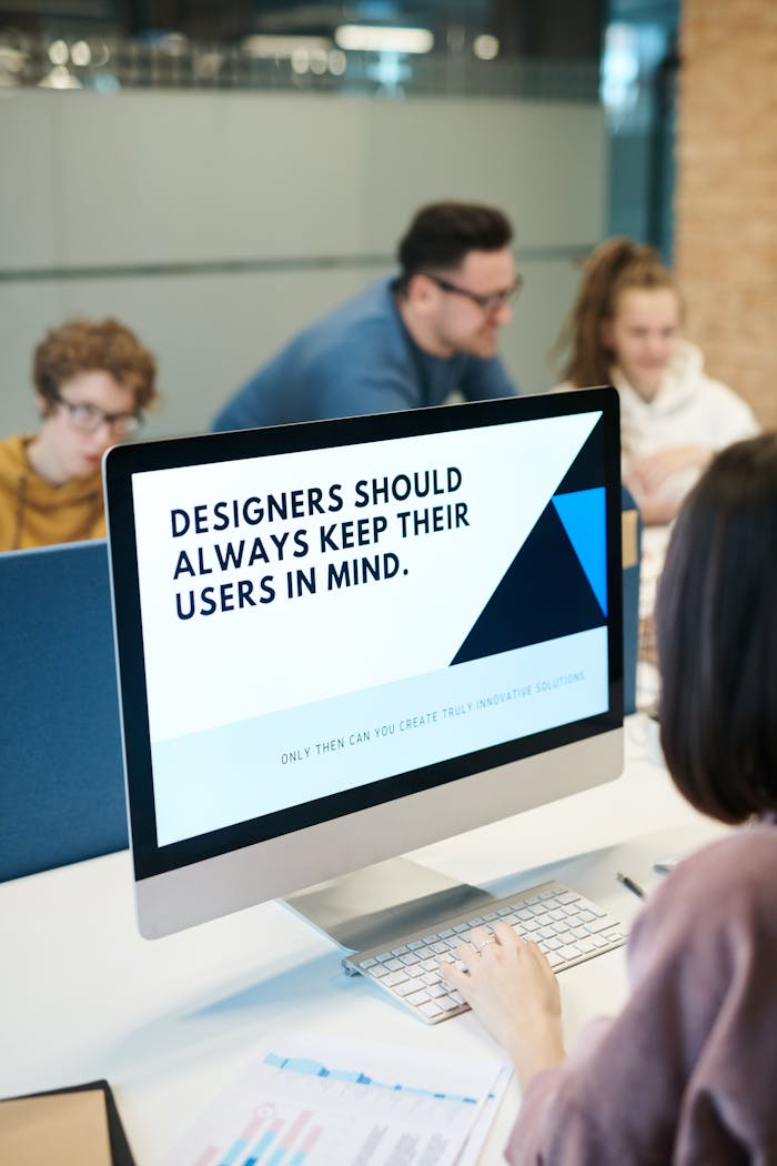 why-choose-us Group of designers collaborating in modern office space with computer.